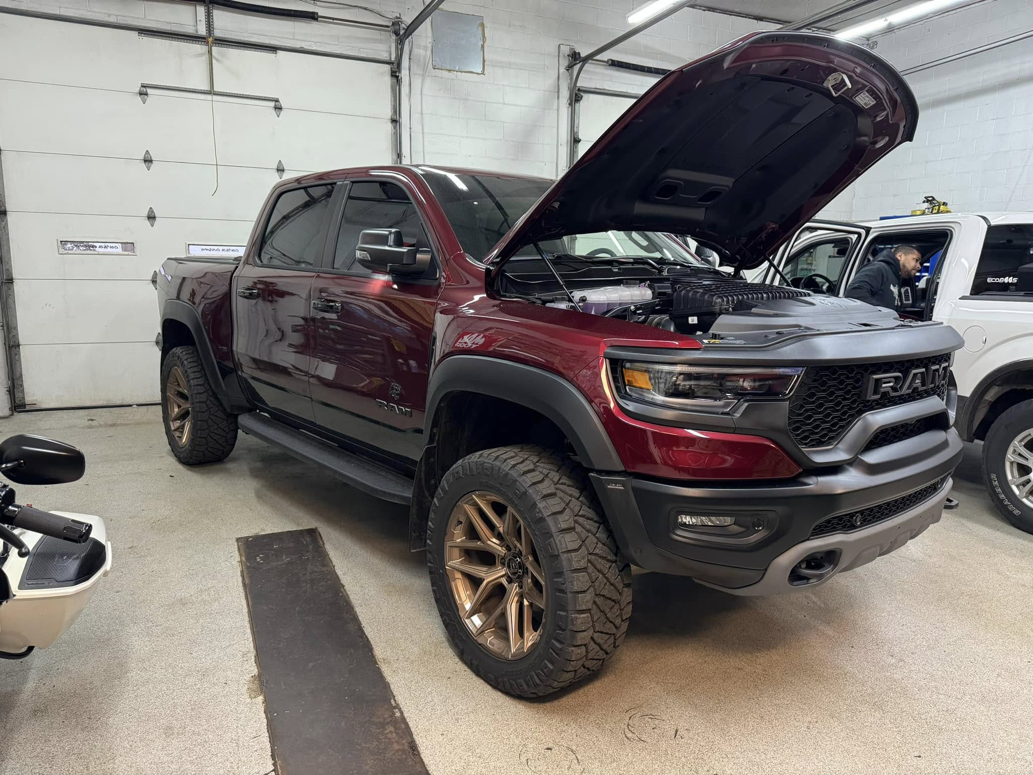 Red Dodge Ram pickup truck in garage